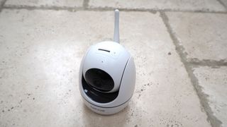 NetVue Orb Mini Home Security Camera on a stone floor