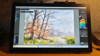 A black drawing tablet on a desk