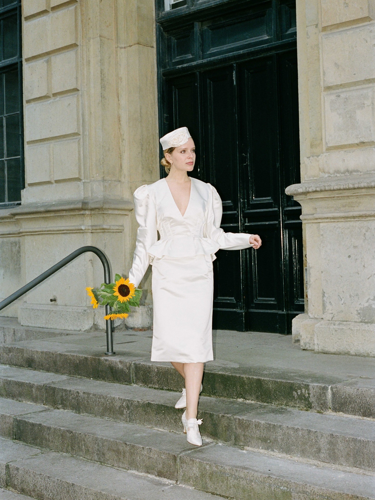 Woman wearing white elopement outfit.
