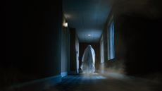 An image showing a ghostly figure walking down a hotel hallway at night