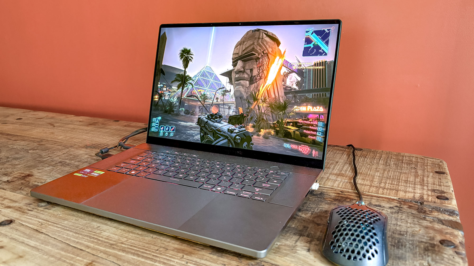 Asus ROG Zephyrus G16 with mouse attached on table with Cyberpunk 2077 on display