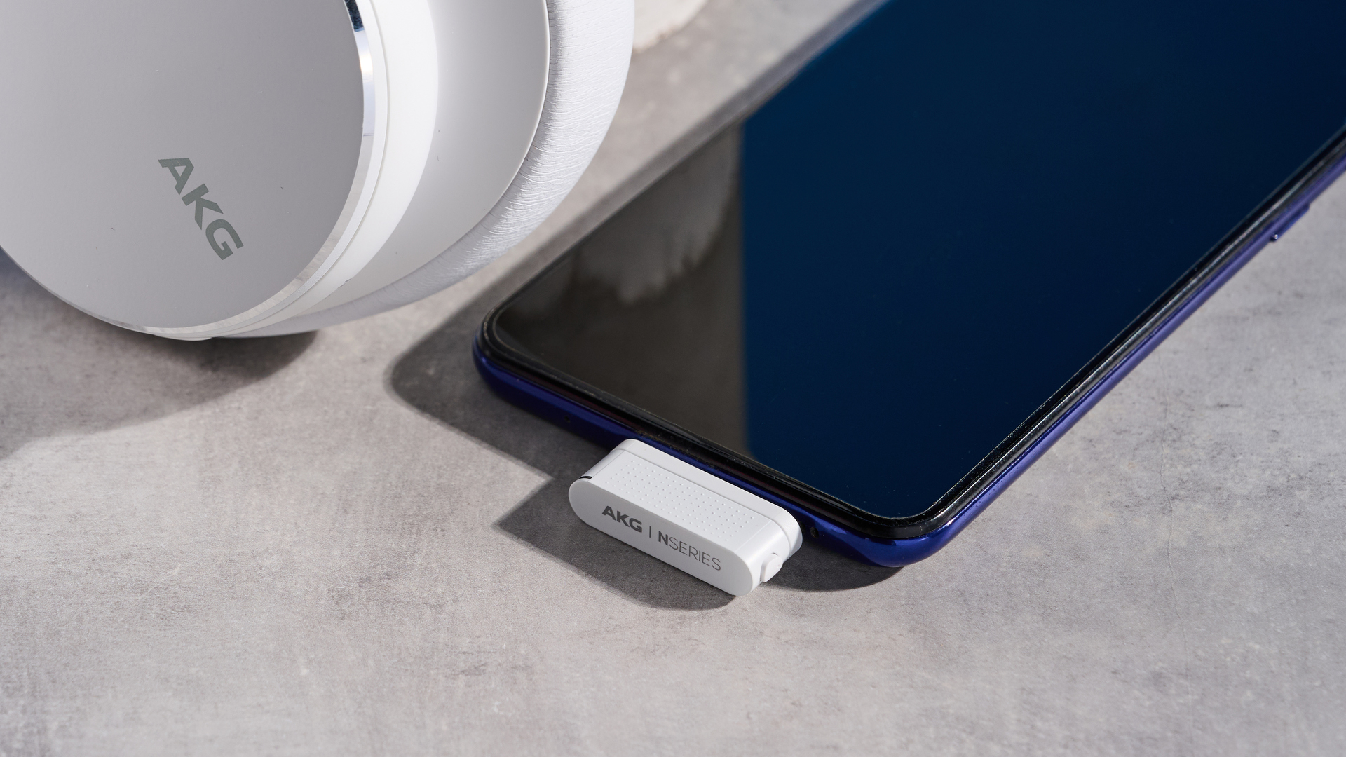 The AKG N9 Hybrid headphones photographed in front of a blue background.