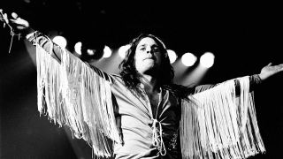 Ozzy Osbourne onstage in his "spaghetti suit", arms outstretched