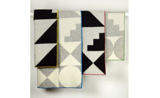 The soft lambswool blankets are edged in multi-coloured blanket stitch