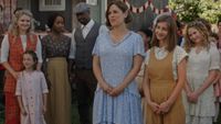 The When Calls the Heart cast standing next to each other and smiling.