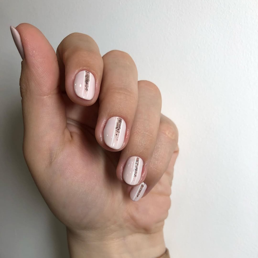 A hand with a glittery engagement manicure.