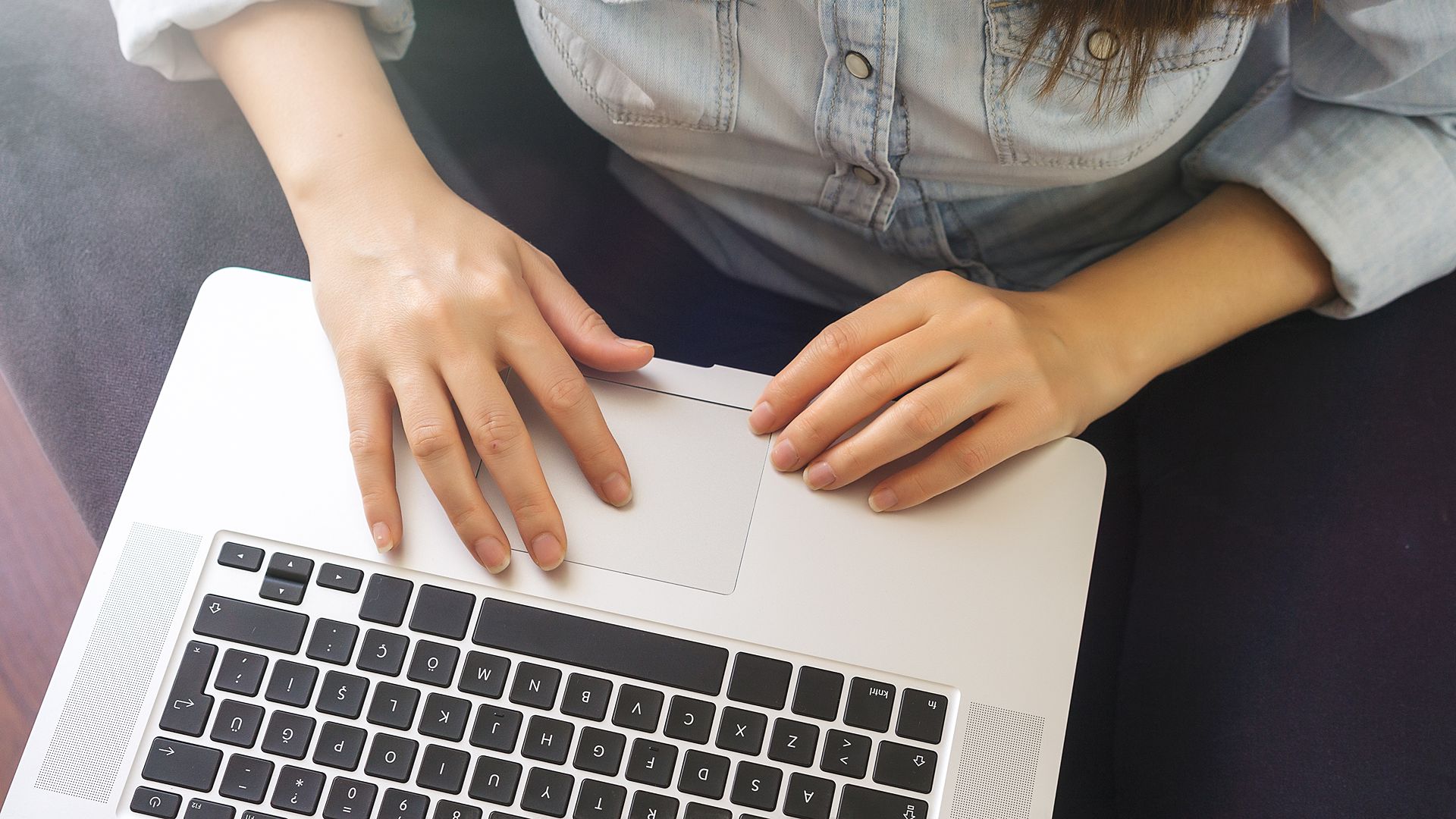shot of woman working on laptop from above