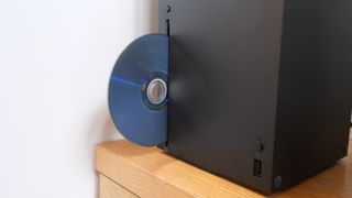 a disc sticks out of the Xbox Series X optical drive