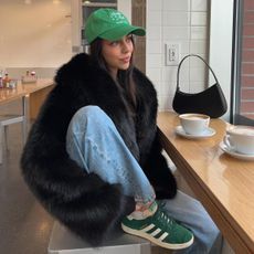 Woman looking out the window at a coffee shop