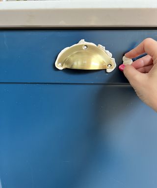 Applying putty to a brass handle to test positioning