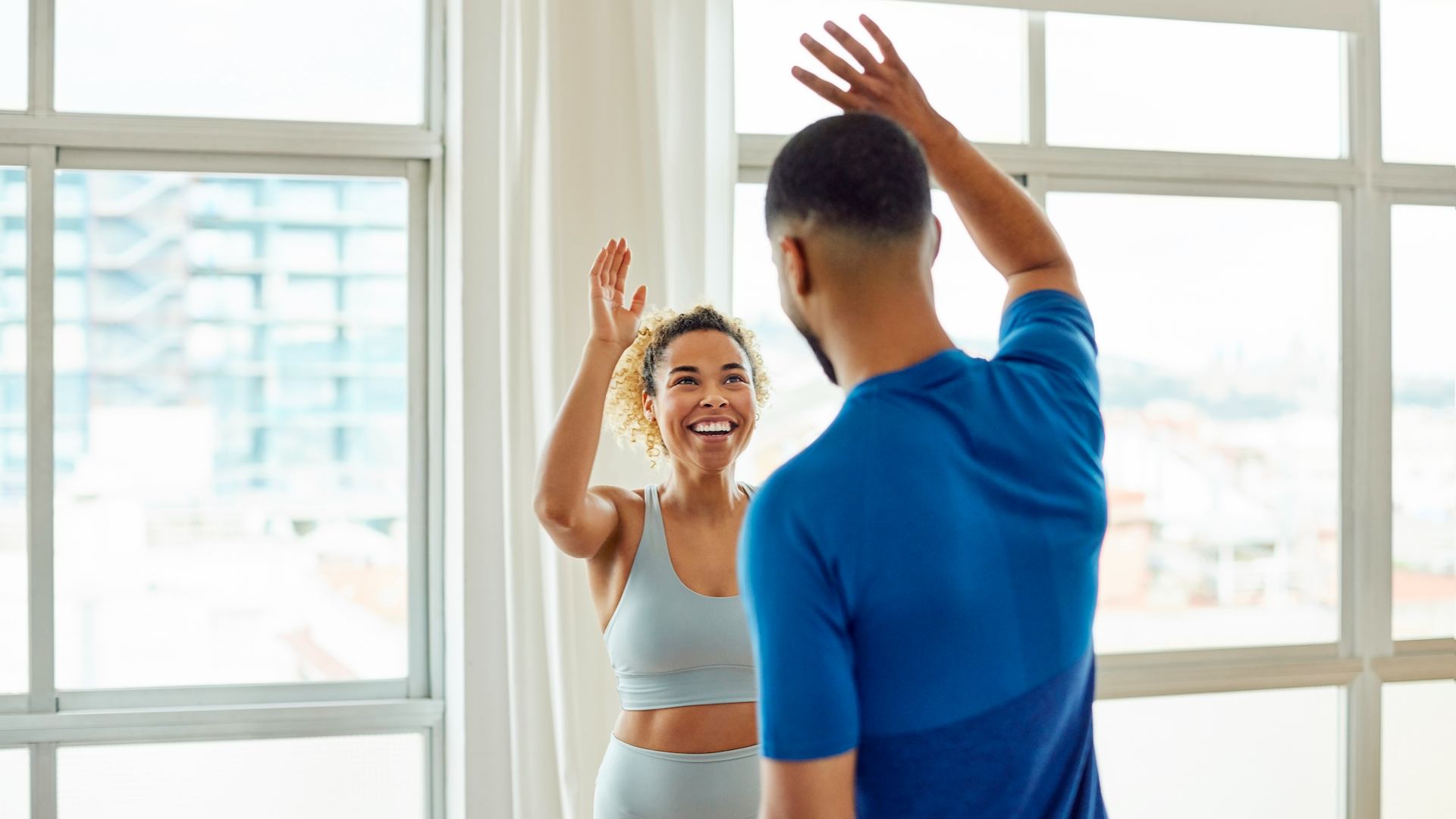 Woman high-fiving her personal trainer