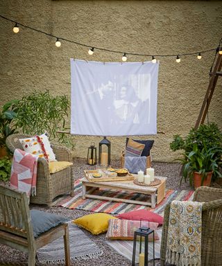 cinema screen in courtyard with festoons and textiles from Walton & Co