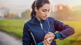 Woman checking sports watch during run