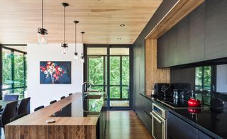 Cedar ceilings extend from the interior out to the underside of the cantilevers. The floors are Quebec ash, indoors and out