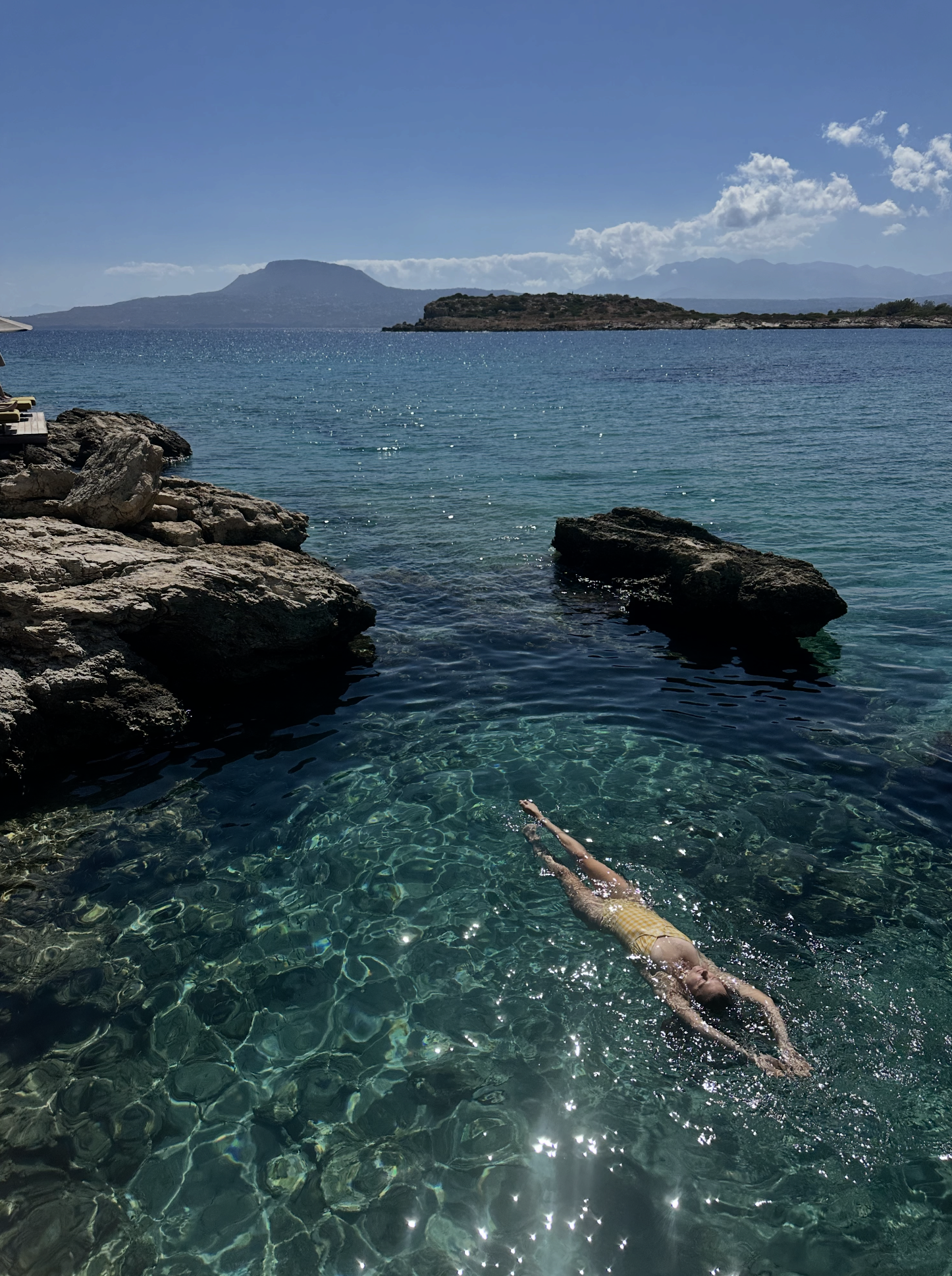 woman floating in water in Crete, Greece