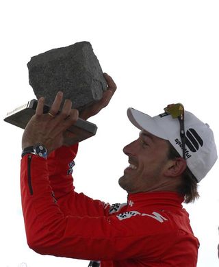 Fabian Cancellara (Saxo Bank) holds up his cobbled trophy