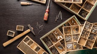 table with hammers, bradol, boxes of nails and screws