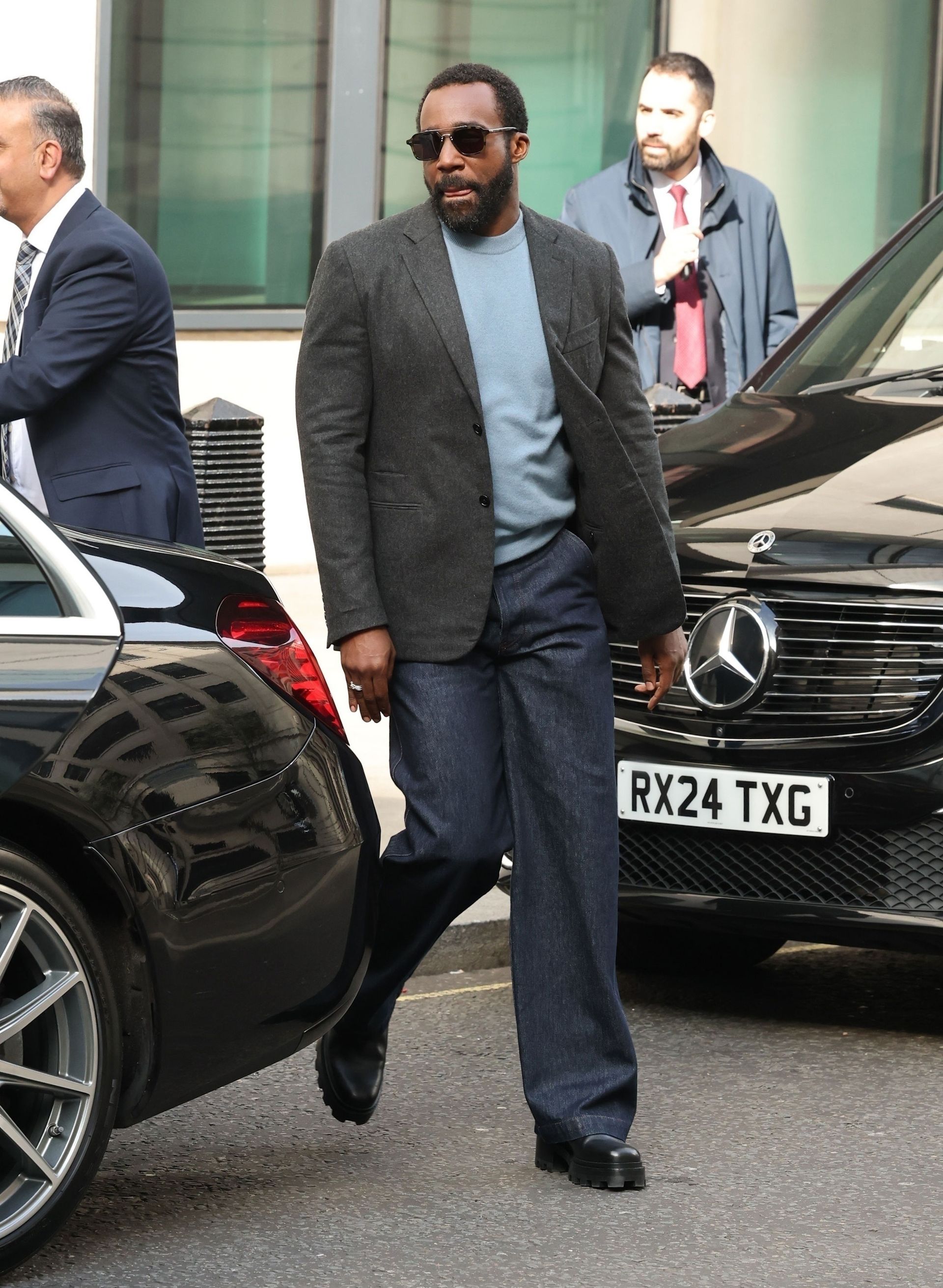 Tramell Tillman wears jeans with a blazer in London in March 2025 - Severance press tour outfits