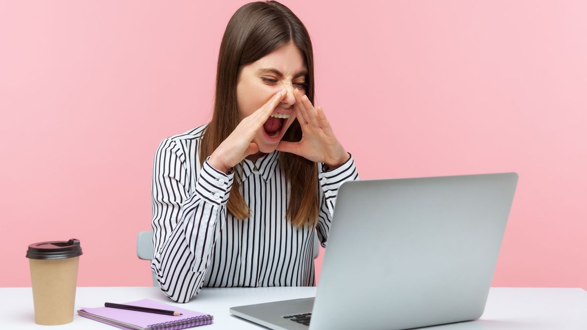 Frustrated person shouting at laptop