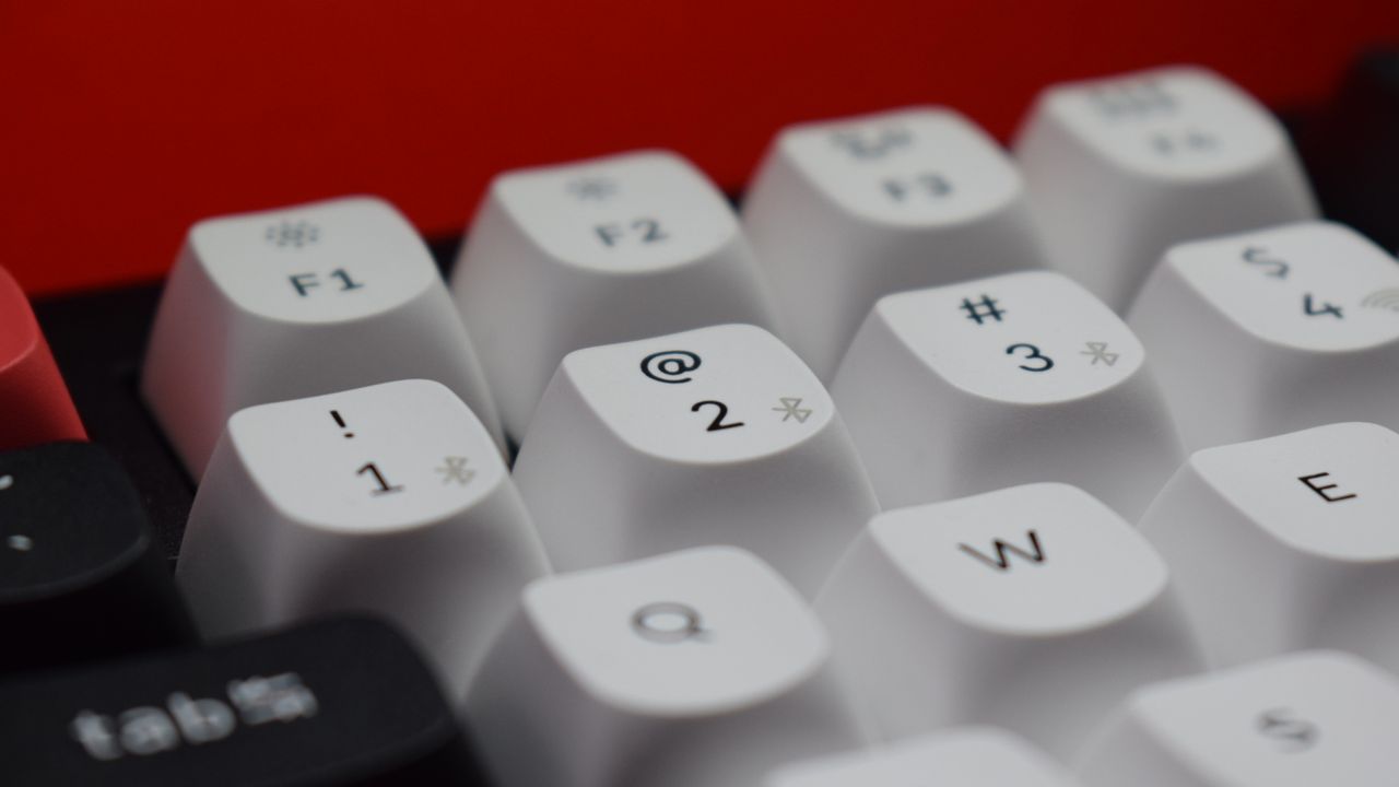 Clos-up photograph of the Keychron Q1 HE wireless keyboard's number keys which also allow control of up to three devices via Bluetooth