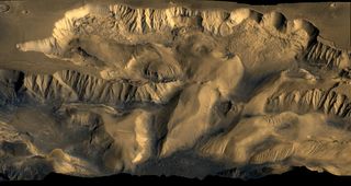 Color mosaic of Viking Orbiter 1 and 2 images showing Candor Chasma, part of the Valles Marineris system on Mars. The walls and floor show evidence of erosion and mass wasting and complex geomorphology.