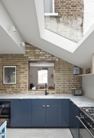 modern pitched roof extension to brick terrace house with rooflight