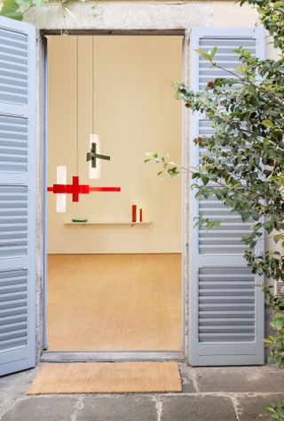 Matisse cut-outs lamps at 5vie on show seen through an open blue door.