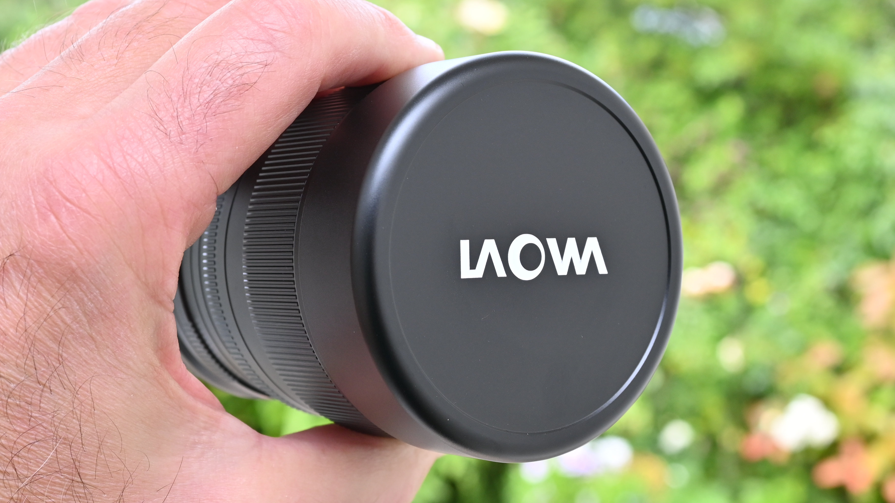Laowa 8-15mm f/2.8 FF Zoom Fisheye product image of lens held in hand
