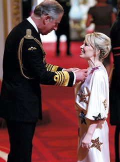 Kylie Minogue receiving an OBE from Prince Charles