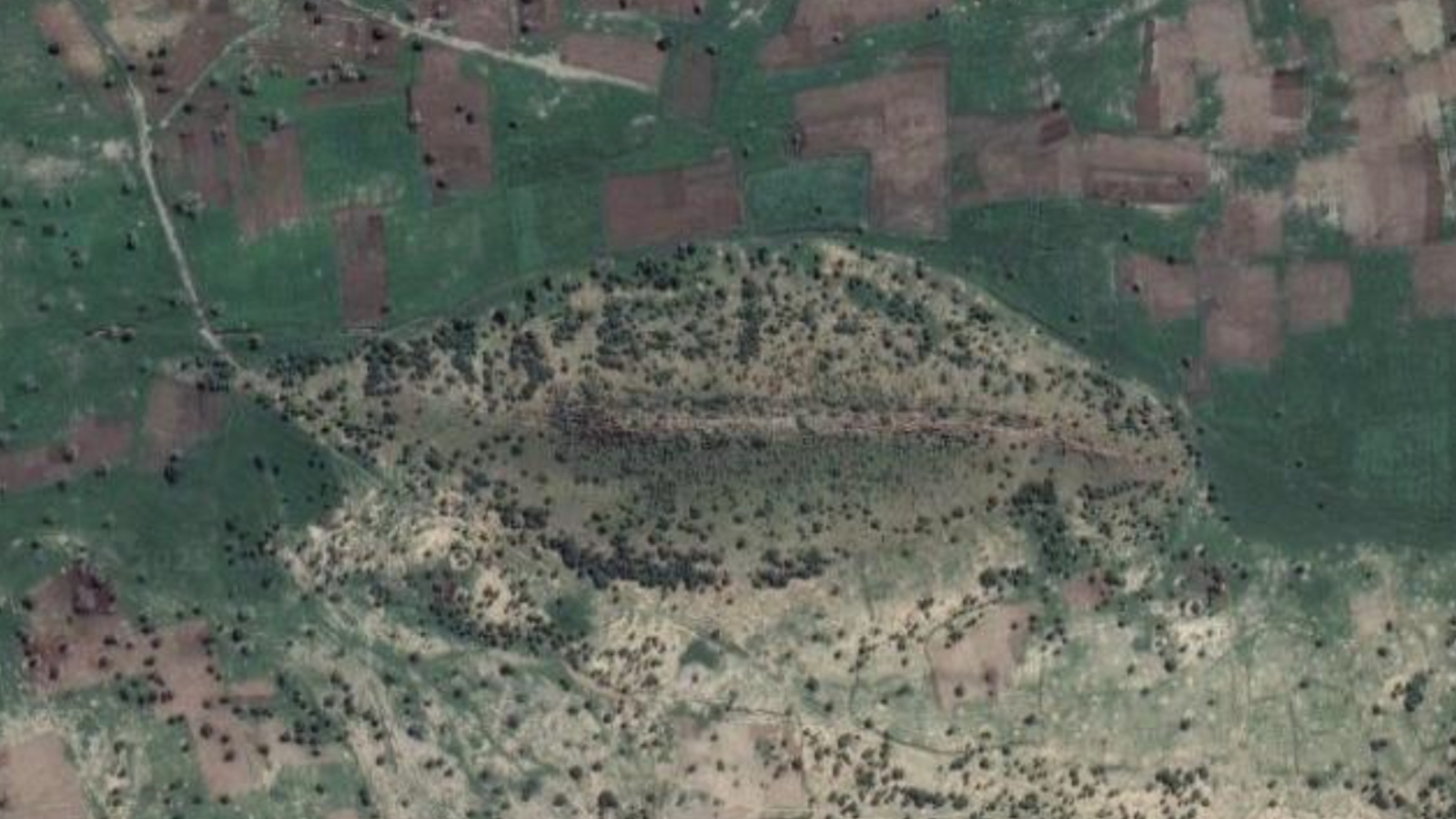 A satellite photo of the hill covered in green and trees
