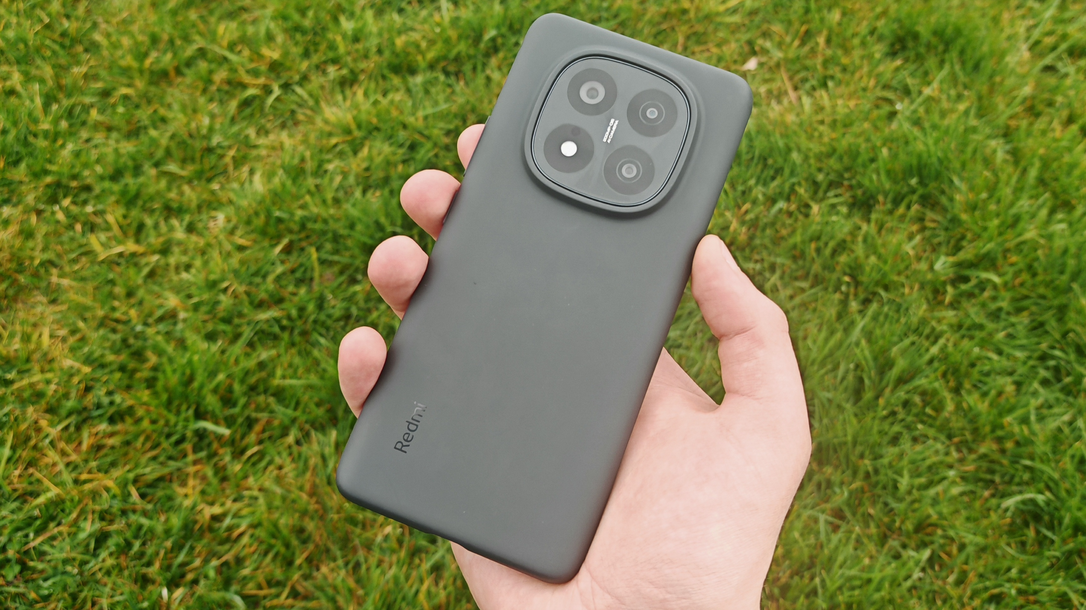Xiaomi Redmi Note 14 Pro Plus 5G phone in hand and on grass showing homescreens and cameras up close