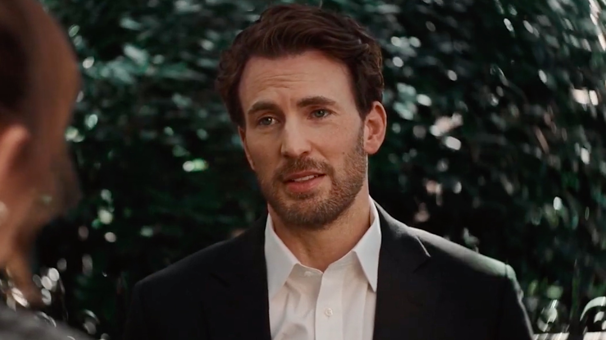 Chris Evans wearing a blazer and collared shirt in Materialists