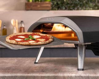pizza cooking in an Ooni Koda 16 pizza oven
