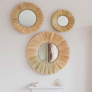room with round grass mirror on white wall