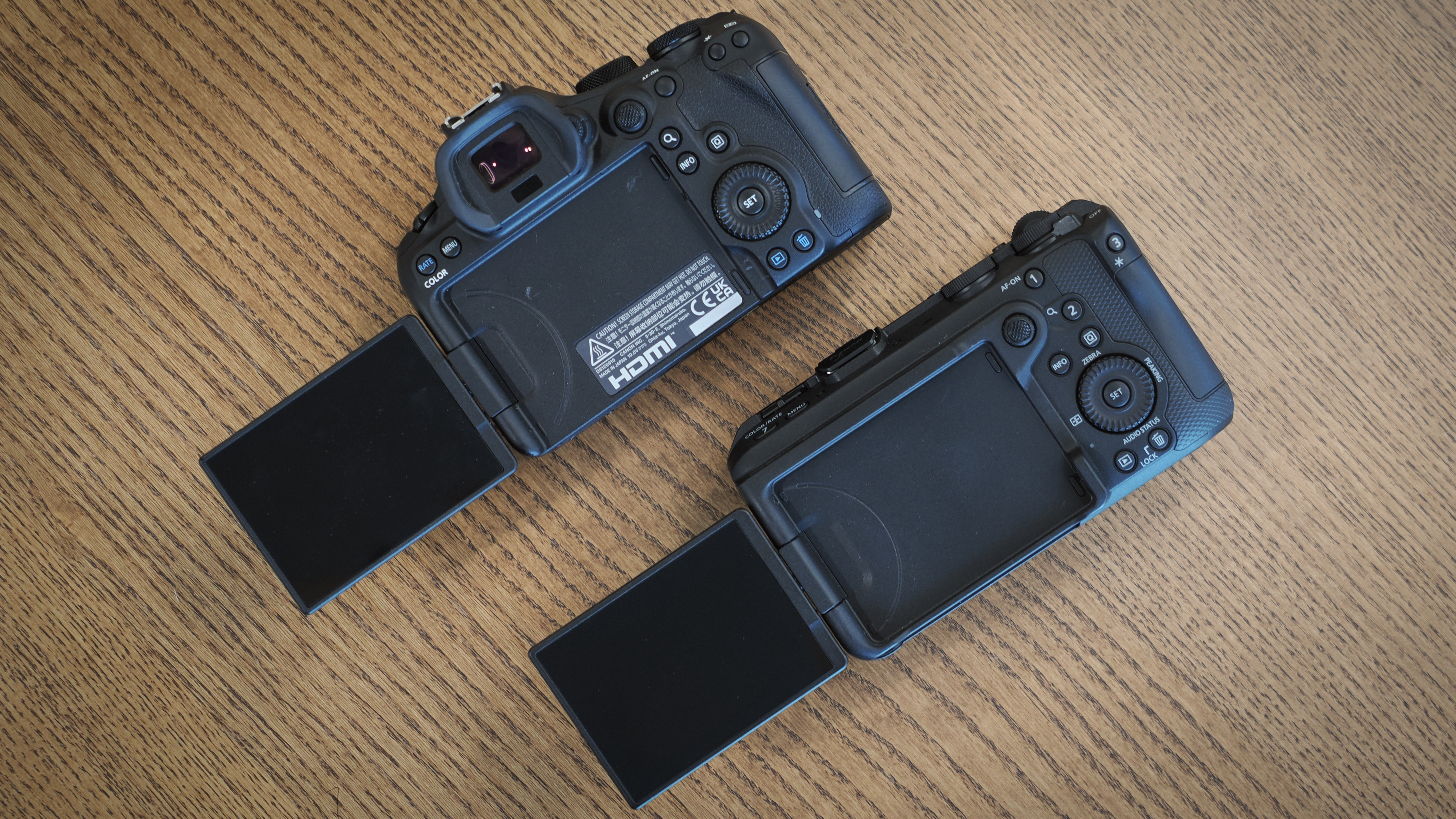 Canon EOS R6 V and R6 Mark III on a wooden surface