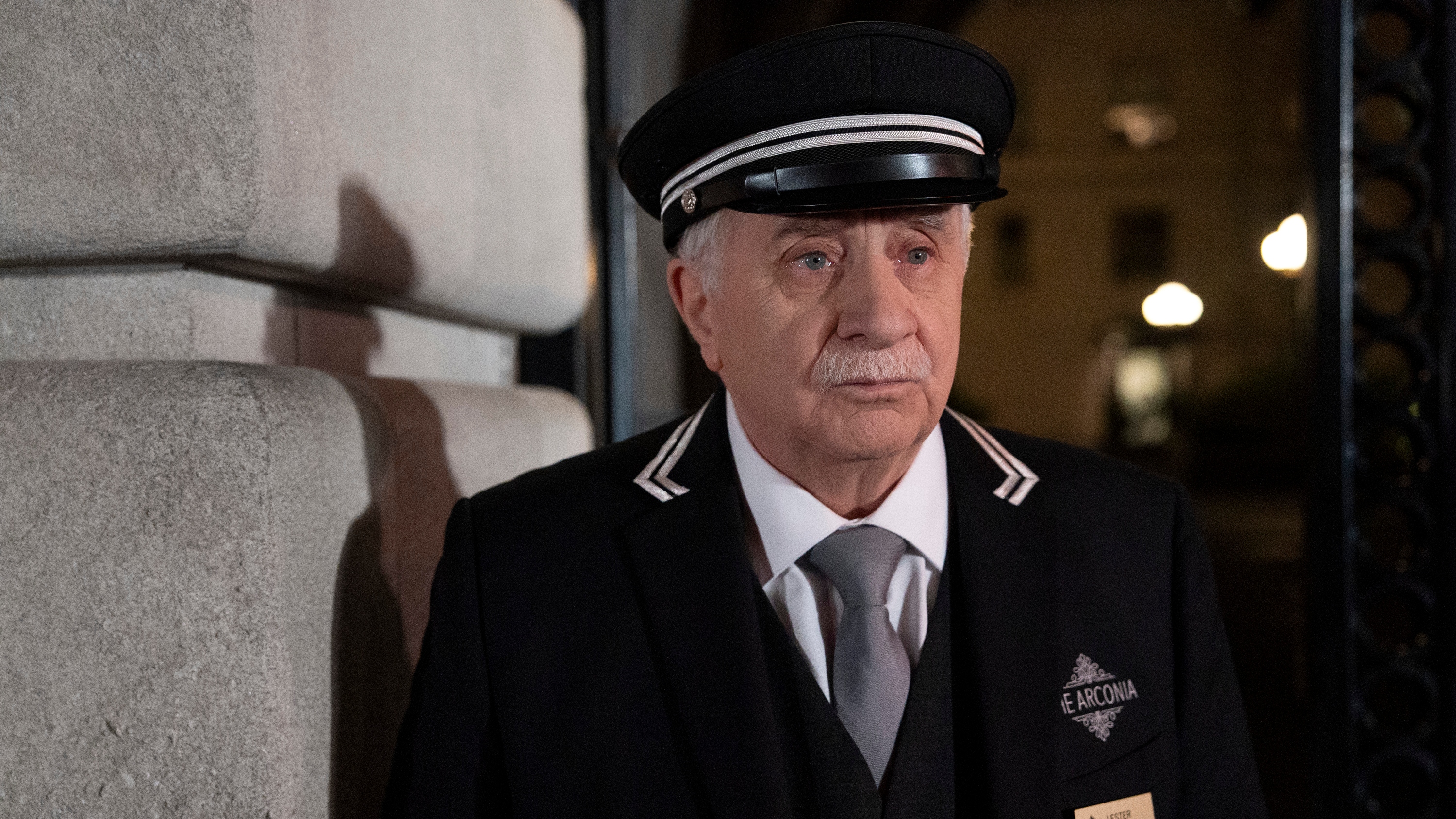 Teddy Coluca in a doorman&#039;s uniform as Lester in Only Murders in the Building