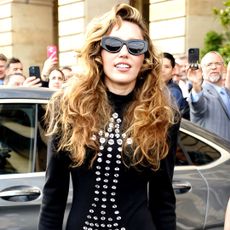 Miley Cyrus wears a vintage Patrick Kelly dress with Eiffel Tower-shaped studs on the front.