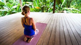 Jade Yoga Mat review: image shows female traveler doing yoga
