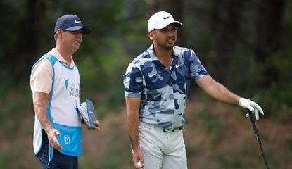 Jason Day talks to his caddie