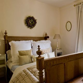 guest bedroom with wooden bed and pillows
