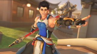 Overwatch 2 Wuyang hero trial preview: Wuyang posing on a bridge, smiling as he points forward with his left and while his right hand is behind his back holding his staff.