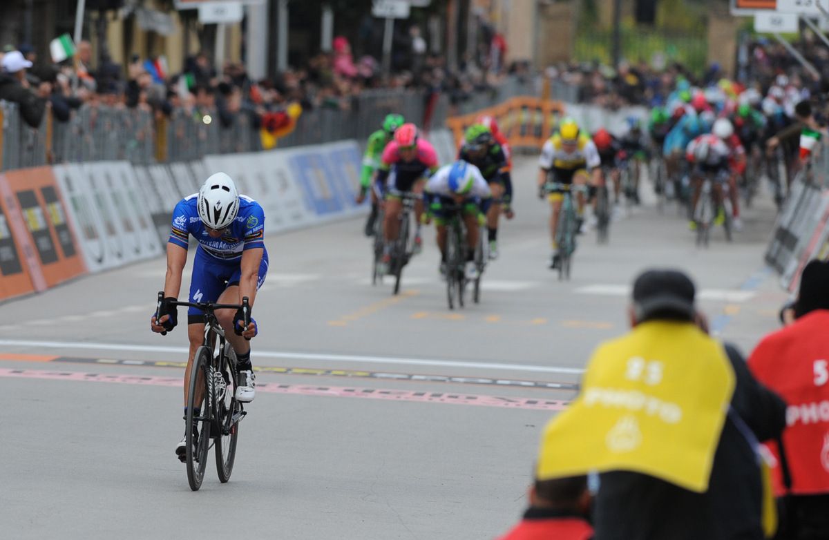 Zdenek Stybar (Etixx-QuickStep) crosses the line with Caleb Ewan getting aero in the background
