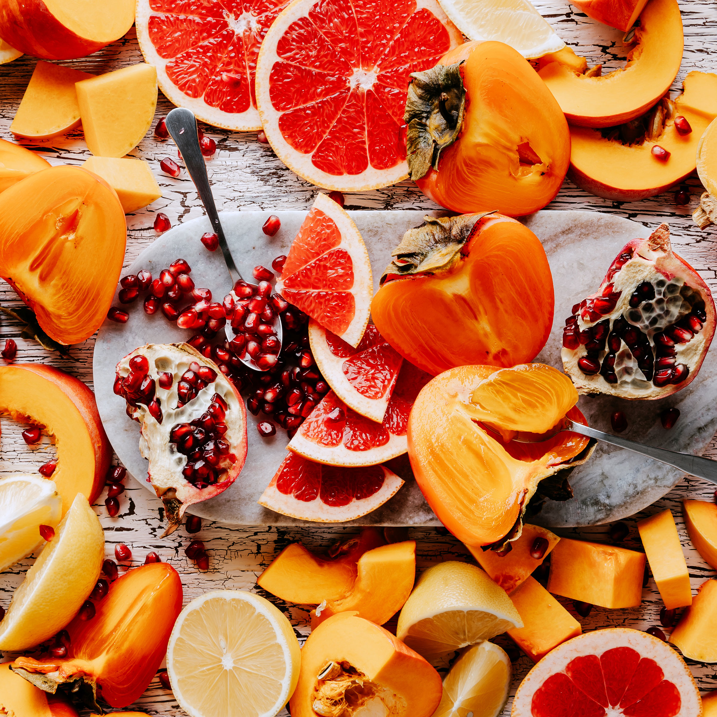 mixed fruits chopped, sliced and crushed on white wooden table