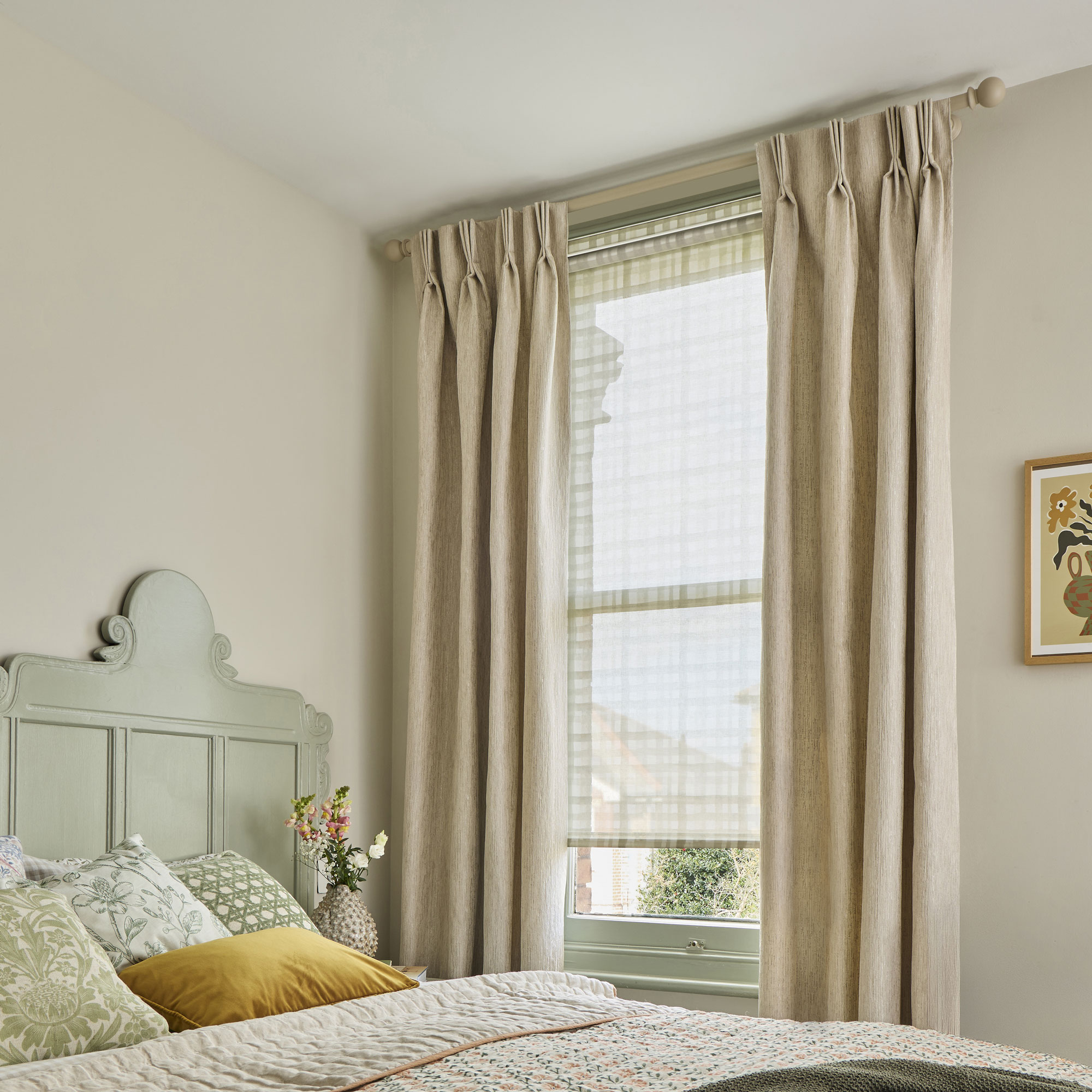 bedroom with full length beige curtains