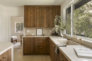 A kitchen with dark wood cabinets