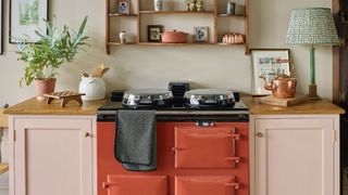 Burnt orange AGA with pink cabinets