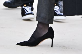 Jennifer Lawrence Dior show fall 2024 black suit coat sheer tights sunglasses low heel pumps Paris Fashion Week