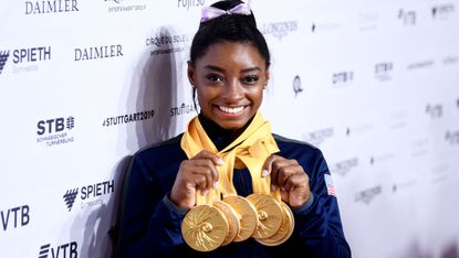stuttgart, germany october 13 simone biles of the united states poses for photos with her multiple gold medals during day 10 of the 49th fig artistic gymnastics world championships at hanns martin schleyer halle on october 13, 2019 in stuttgart, germany photo by laurence griffithsgetty images