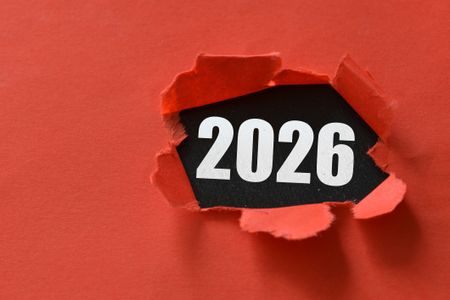 2026 numbers showing through a ripped red paper
