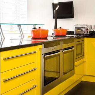 yellow kitchen with hob and ovens